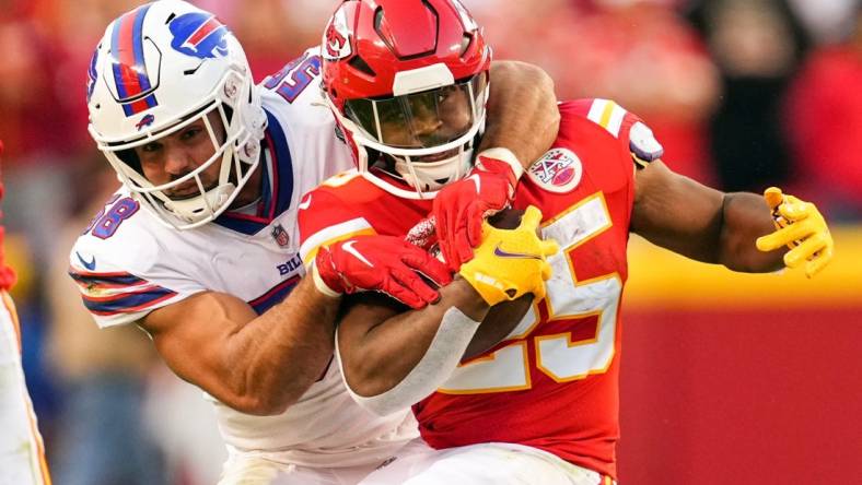 Oct 16, 2022; Kansas City, Missouri, USA; Kansas City Chiefs running back Clyde Edwards-Helaire (25) is tackled by Buffalo Bills linebacker Matt Milano (58) during the second half at GEHA Field at Arrowhead Stadium. Mandatory Credit: Jay Biggerstaff-USA TODAY Sports