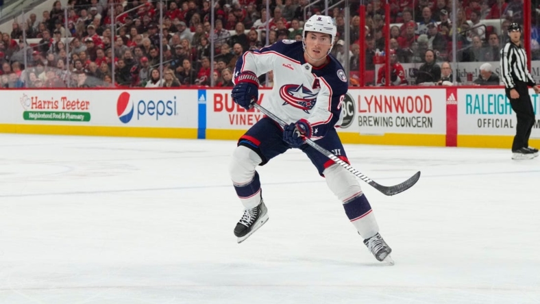 Oct 12, 2022; Raleigh, North Carolina, USA;  Columbus Blue Jackets defenseman Zach Werenski (8) passes the puck against the Carolina Hurricanes during the second period at PNC Arena. Mandatory Credit: James Guillory-USA TODAY Sports