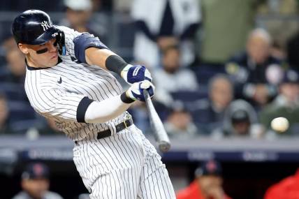 Oct 18, 2022; Bronx, New York, USA; New York Yankees right fielder Aaron Judge (99) hits a single against the Cleveland Guardians during the seventh inning in game five of the ALDS for the 2022 MLB Playoffs at Yankee Stadium. Mandatory Credit: Brad Penner-USA TODAY Sports