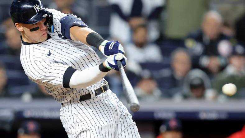 Oct 18, 2022; Bronx, New York, USA; New York Yankees right fielder Aaron Judge (99) hits a single against the Cleveland Guardians during the seventh inning in game five of the ALDS for the 2022 MLB Playoffs at Yankee Stadium. Mandatory Credit: Brad Penner-USA TODAY Sports