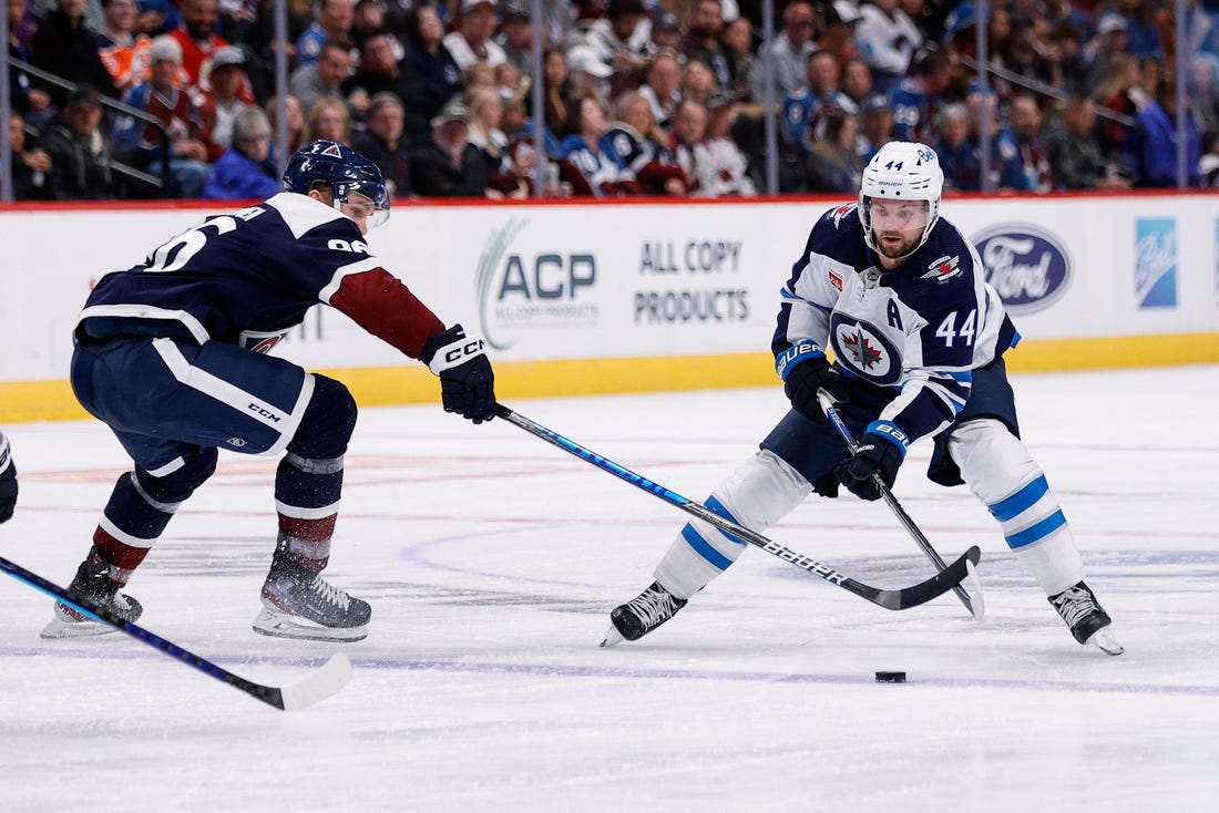 Oct 19, 2022; Denver, Colorado, USA; Winnipeg Jets defenseman Josh Morrissey (44) controls the puck as Colorado Avalanche right wing Mikko Rantanen (96) defends in the third period at Ball Arena. Mandatory Credit: Isaiah J. Downing-USA TODAY Sports