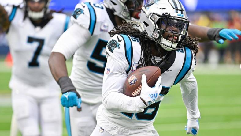 Oct 16, 2022; Inglewood, California, USA;  Carolina Panthers cornerback Donte Jackson (26) runs back an intercepted pass for a touchdown during an NFL game against the Los Angeles Rams at SoFi Stadium. Mandatory Credit: Robert Hanashiro-USA TODAY Sports