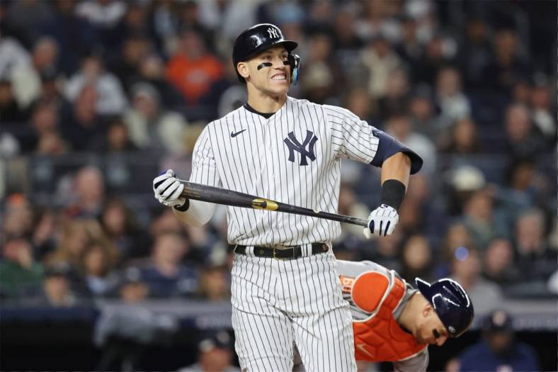 Oct 22, 2022; Bronx, New York, USA; New York Yankees right fielder Aaron Judge (99) reacts after striking out in the sixth inning against the Houston Astros during game three of the ALCS for the 2022 MLB Playoffs at Yankee Stadium. Mandatory Credit: Brad Penner-USA TODAY Sports