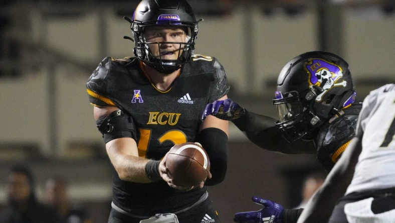 Oct 22, 2022; Greenville, North Carolina, USA;  East Carolina Pirates quarterback Holton Ahlers (12) gets ready too hand the ball off against the UCF Knights during the second half at Dowdy-Ficklen Stadium. Mandatory Credit: James Guillory-USA TODAY Sports