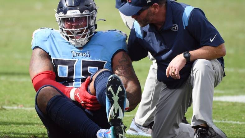 Oct 23, 2022; Nashville, Tennessee, USA; Tennessee Titans defensive tackle Jeffery Simmons (98) grabs his leg after an injury during the second half against the Indianapolis Colts at Nissan Stadium. Mandatory Credit: Christopher Hanewinckel-USA TODAY Sports