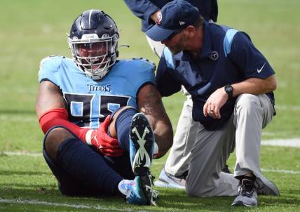 Oct 23, 2022; Nashville, Tennessee, USA; Tennessee Titans defensive tackle Jeffery Simmons (98) grabs his leg after an injury during the second half against the Indianapolis Colts at Nissan Stadium. Mandatory Credit: Christopher Hanewinckel-USA TODAY Sports