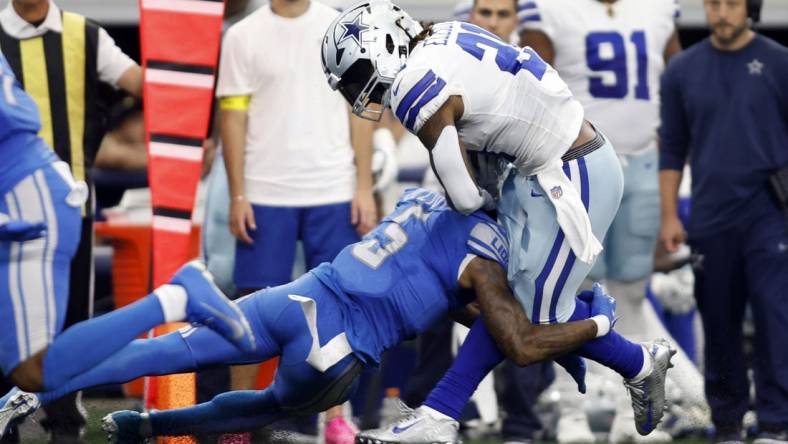 Oct 23, 2022; Arlington, Texas, USA; Dallas Cowboys running back Ezekiel Elliott (21) is tackled by Detroit Lions safety DeShon Elliott (5) in the second quarter at AT&T Stadium. Mandatory Credit: Tim Heitman-USA TODAY Sports