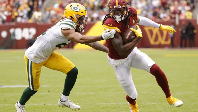 Oct 23, 2022; Landover, Maryland, USA; Washington Commanders wide receiver Cam Sims (89) runs with the ball as Green Bay Packers cornerback Eric Stokes (21) chased during the fourth quarter at FedExField. Mandatory Credit: Geoff Burke-USA TODAY Sports