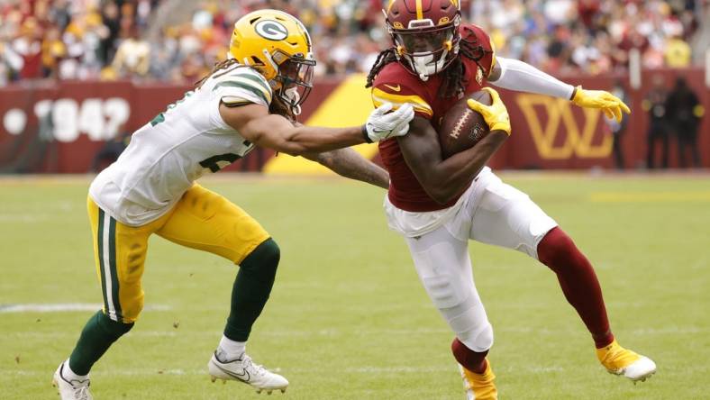 Oct 23, 2022; Landover, Maryland, USA; Washington Commanders wide receiver Cam Sims (89) runs with the ball as Green Bay Packers cornerback Eric Stokes (21) chased during the fourth quarter at FedExField. Mandatory Credit: Geoff Burke-USA TODAY Sports