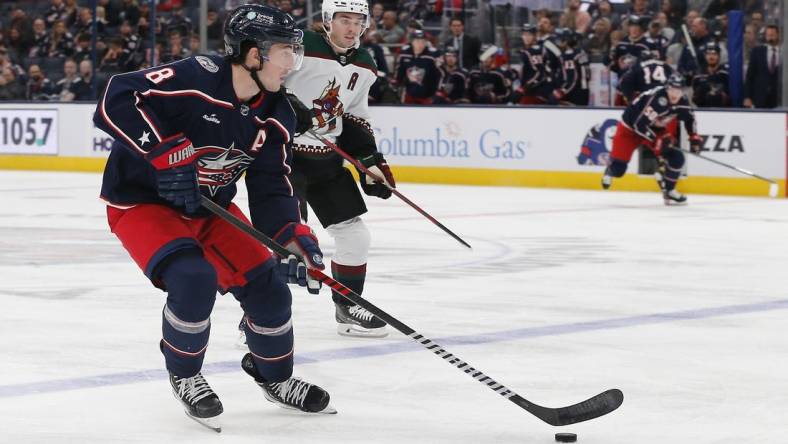 Oct 25, 2022; Columbus, Ohio, USA; Columbus Blue Jackets defenseman Zach Werenski (8) looks to pass as Arizona Coyotes defenseman Josh Brown (3) trails the play during the third period at Nationwide Arena. Mandatory Credit: Russell LaBounty-USA TODAY Sports