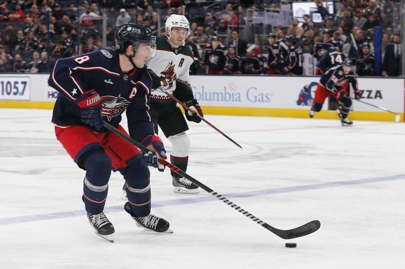 Oct 25, 2022; Columbus, Ohio, USA; Columbus Blue Jackets defenseman Zach Werenski (8) looks to pass as Arizona Coyotes defenseman Josh Brown (3) trails the play during the third period at Nationwide Arena. Mandatory Credit: Russell LaBounty-USA TODAY Sports