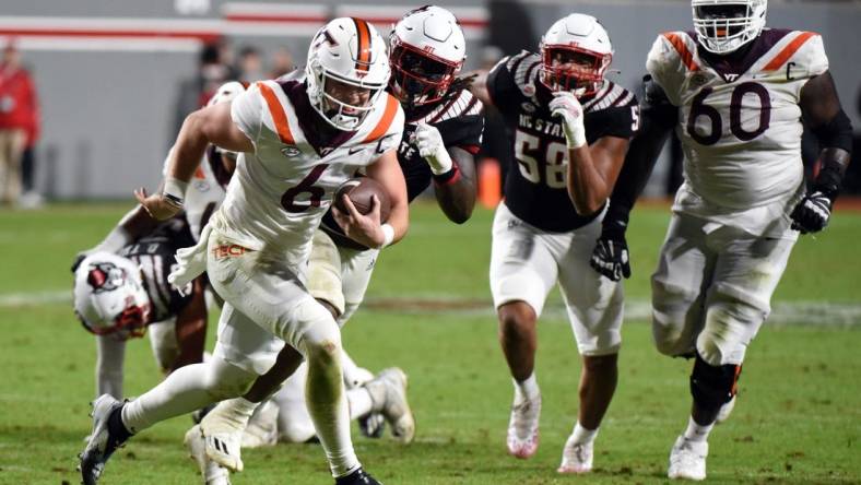 Oct 27, 2022; Raleigh, North Carolina, USA; Virginia Tech Hokies quarterback Grant Wells (6) runs for a touchdown during the second half against the North Carolina State Wolfpack at Carter-Finley Stadium.  The Wolfpack won 22-21. Mandatory Credit: Rob Kinnan-USA TODAY Sports