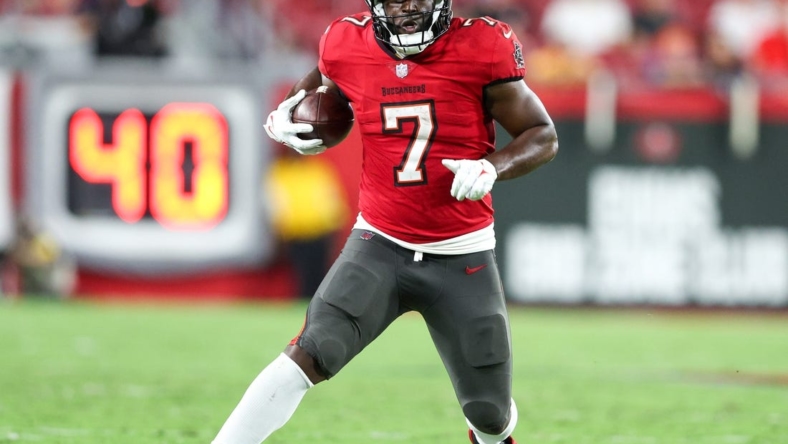 Oct 27, 2022; Tampa, Florida, USA;  Tampa Bay Buccaneers running back Leonard Fournette (7) runs with the ball against the Baltimore Ravens in the fourth quarter at Raymond James Stadium. Mandatory Credit: Nathan Ray Seebeck-USA TODAY Sports