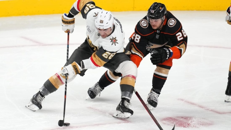 Oct 28, 2022; Las Vegas, Nevada, USA; Vegas Golden Knights left wing William Carrier (28) skates against Anaheim Ducks defenseman Nathan Beaulieu (28) during the third period at T-Mobile Arena. Mandatory Credit: Stephen R. Sylvanie-USA TODAY Sports