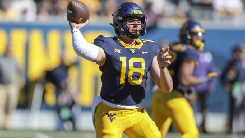 Oct 29, 2022; Morgantown, West Virginia, USA; West Virginia Mountaineers quarterback JT Daniels (18) throws a pass during the second quarter against the TCU Horned Frogs at Mountaineer Field at Milan Puskar Stadium. Mandatory Credit: Ben Queen-USA TODAY Sports