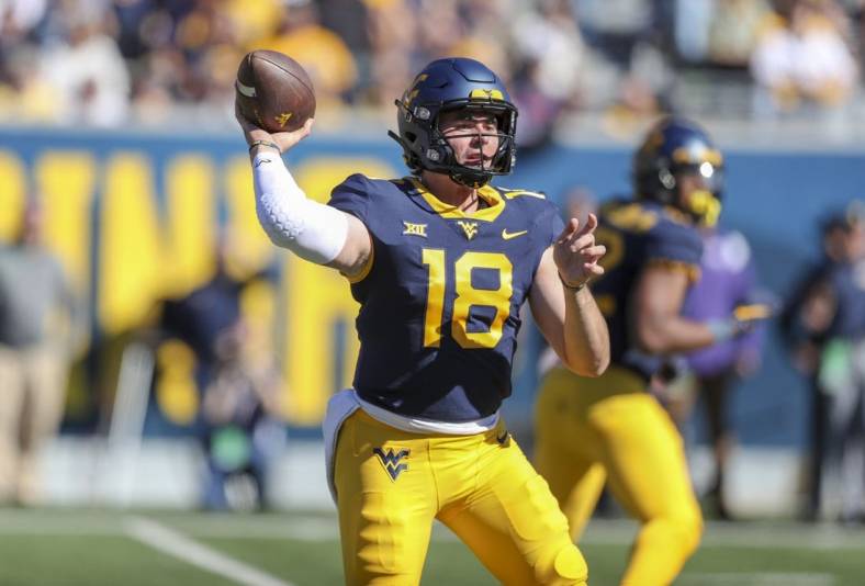 Oct 29, 2022; Morgantown, West Virginia, USA; West Virginia Mountaineers quarterback JT Daniels (18) throws a pass during the second quarter against the TCU Horned Frogs at Mountaineer Field at Milan Puskar Stadium. Mandatory Credit: Ben Queen-USA TODAY Sports