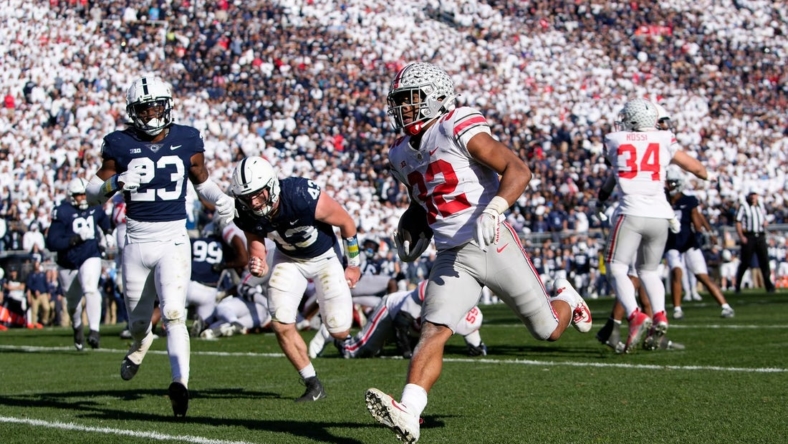 Oct 29, 2022; University Park, Pennsylvania, USA; Ohio State Buckeyes running back TreVeyon Henderson (32) runs for a 7-yard touchdown past Penn State Nittany Lions linebacker Tyler Elsdon (43) and linebacker Curtis Jacobs (23) during the fourth quarter of the NCAA Division I football game at Beaver Stadium. Mandatory Credit: Adam Cairns-The Columbus Dispatch

Ncaa Football Ohio State Buckeyes At Penn State Nittany Lions