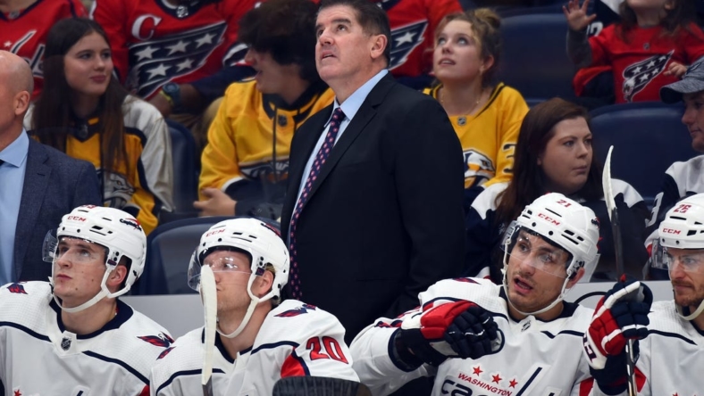 Oct 29, 2022; Nashville, Tennessee, USA; Washington Capitals head coach Peter Laviolette watches from the bench during the first period against the Nashville Predators at Bridgestone Arena. Mandatory Credit: Christopher Hanewinckel-USA TODAY Sports