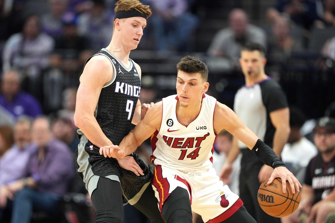 Oct 29, 2022; Sacramento, California, USA; Miami Heat guard Tyler Herro (14) dribbles the ball against Sacramento Kings guard Kevin Huerter (9) during the third quarter at Golden 1 Center. Mandatory Credit: Darren Yamashita-USA TODAY Sports