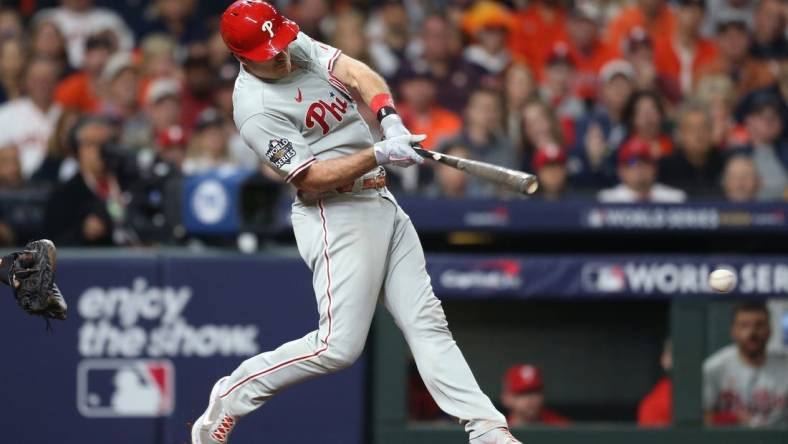 Oct 29, 2022; Houston, Texas, USA; Philadelphia Phillies catcher J.T. Realmuto (10) hits a single during the eighth inning against the Houston Astros in game two of the 2022 World Series at Minute Maid Park. Mandatory Credit: Thomas Shea-USA TODAY Sports