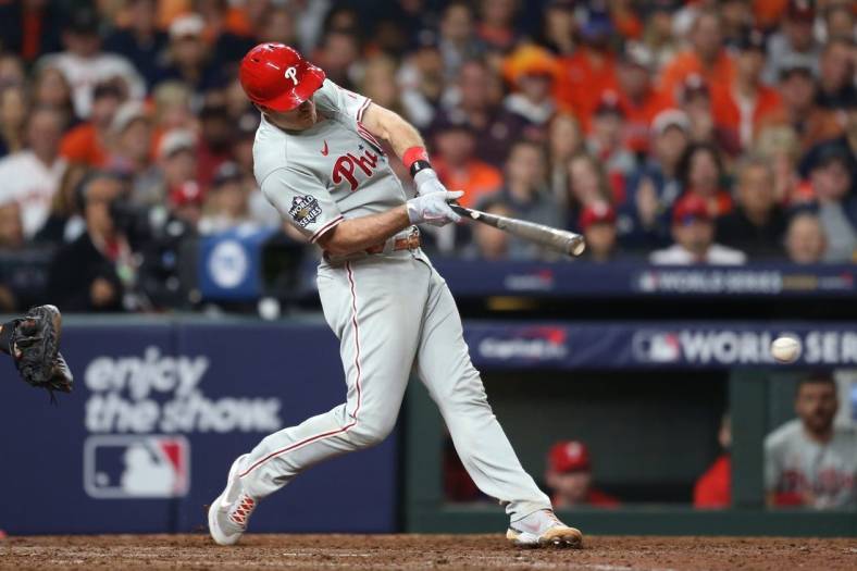 Oct 29, 2022; Houston, Texas, USA; Philadelphia Phillies catcher J.T. Realmuto (10) hits a single during the eighth inning against the Houston Astros in game two of the 2022 World Series at Minute Maid Park. Mandatory Credit: Thomas Shea-USA TODAY Sports