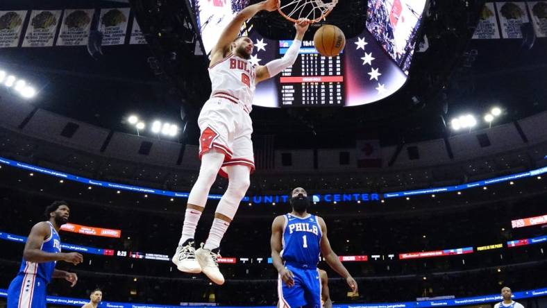 Oct 29, 2022; Chicago, Illinois, USA; Chicago Bulls guard Zach LaVine (8) dunks the ball as Philadelphia 76ers guard James Harden (1) stands nearby during the second half at United Center. Mandatory Credit: David Banks-USA TODAY Sports