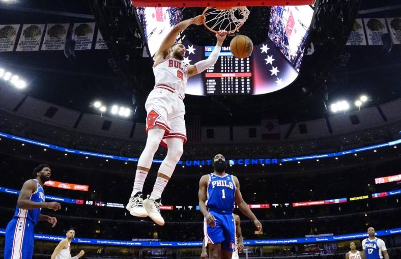 Oct 29, 2022; Chicago, Illinois, USA; Chicago Bulls guard Zach LaVine (8) dunks the ball as Philadelphia 76ers guard James Harden (1) stands nearby during the second half at United Center. Mandatory Credit: David Banks-USA TODAY Sports