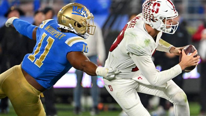 Oct 29, 2022; Pasadena, California, USA;   Stanford Cardinal quarterback Tanner McKee (18) is pressured by UCLA Bruins defensive lineman Gabriel Murphy (11) in the second half at the Rose Bowl. Mandatory Credit: Jayne Kamin-Oncea-USA TODAY Sports