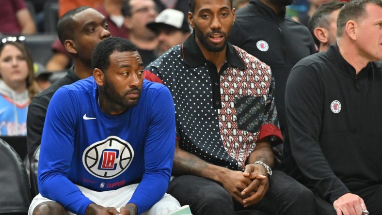 Oct 30, 2022; Los Angeles, California, USA;  Los Angeles Clippers forward Kawhi Leonard (2) sits next to guard John Wall (11) on from the bench in the first half at Crypto.com Arena. Mandatory Credit: Jayne Kamin-Oncea-USA TODAY Sports
