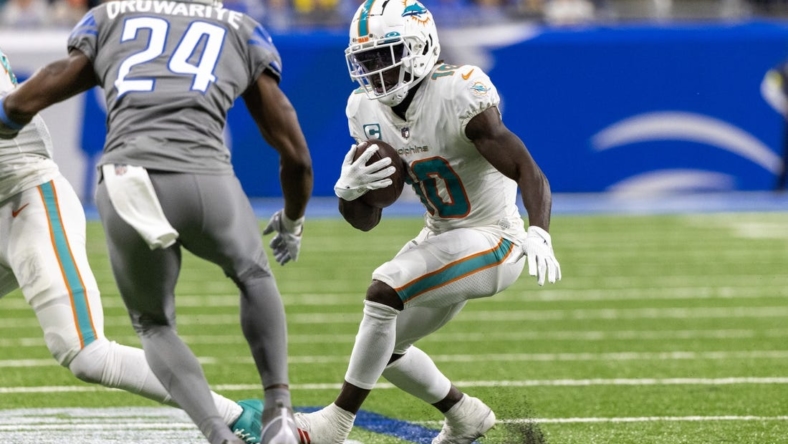 Oct 30, 2022; Detroit, Michigan, USA; Miami Dolphins wide receiver Tyreek Hill (10) runs with the ball against the Detroit Lions during the second half at Ford Field. Mandatory Credit: David Reginek-USA TODAY Sports