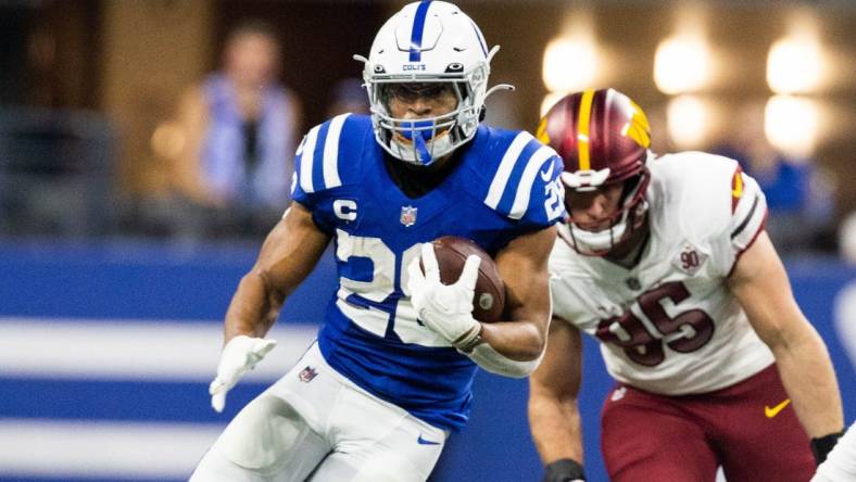 Oct 30, 2022; Indianapolis, Indiana, USA; Indianapolis Colts running back Jonathan Taylor (28) runs the ball in the first quarter against the Washington Commanders at Lucas Oil Stadium. Mandatory Credit: Trevor Ruszkowski-USA TODAY Sports