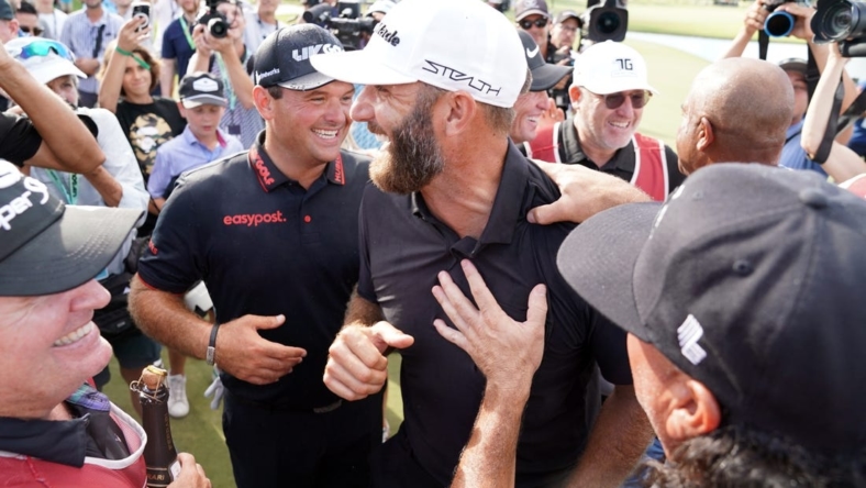 Oct 30, 2022; Miami, Florida, USA; Patrick Reed and Dustin Johnson celebrate with team 4Aces GC after winning the season finale of the LIV Golf series at Trump National Doral. Mandatory Credit: John David Mercer-USA TODAY Sports