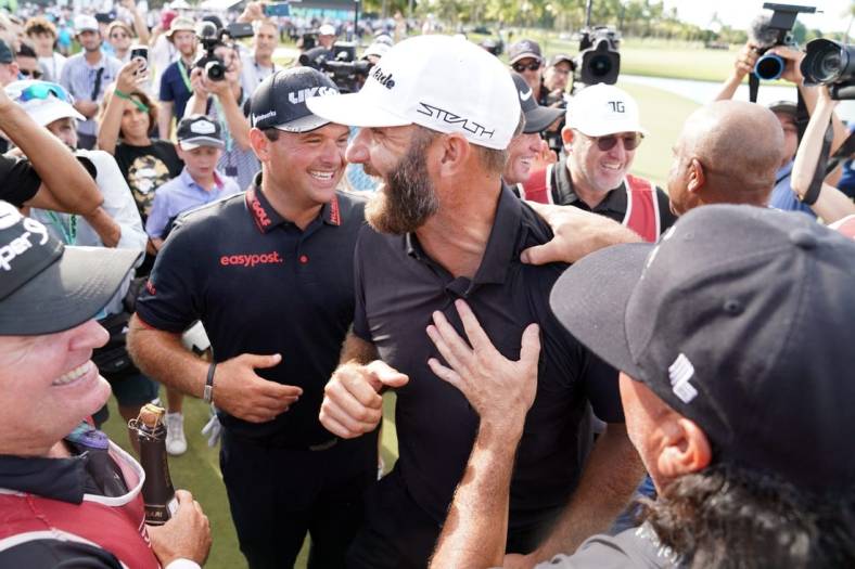 Oct 30, 2022; Miami, Florida, USA; Patrick Reed and Dustin Johnson celebrate with team 4Aces GC after winning the season finale of the LIV Golf series at Trump National Doral. Mandatory Credit: John David Mercer-USA TODAY Sports