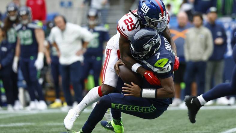 Oct 30, 2022; Seattle, Washington, USA; New York Giants safety Xavier McKinney (29) sacks Seattle Seahawks quarterback Geno Smith (7)  during the second quarter at Lumen Field. Mandatory Credit: Joe Nicholson-USA TODAY Sports