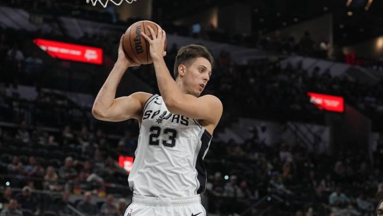 Oct 30, 2022; San Antonio, Texas, USA; San Antonio Spurs forward Zach Collins (23) rebounds in the second half against the Minnesota Timberwolves at the AT&T Center. Mandatory Credit: Daniel Dunn-USA TODAY Sports