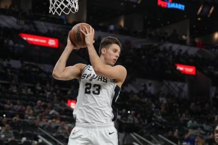 Oct 30, 2022; San Antonio, Texas, USA; San Antonio Spurs forward Zach Collins (23) rebounds in the second half against the Minnesota Timberwolves at the AT&T Center. Mandatory Credit: Daniel Dunn-USA TODAY Sports