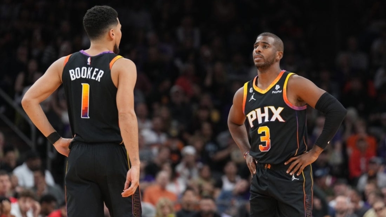 Oct 30, 2022; Phoenix, Arizona, USA; Phoenix Suns guard Devin Booker (1) and Phoenix Suns guard Chris Paul (3) look on against the Houston Rockets during the first half at Footprint Center. Mandatory Credit: Joe Camporeale-USA TODAY Sports