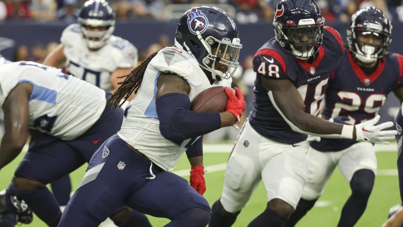 Oct 30, 2022; Houston, Texas, USA; Tennessee Titans running back Derrick Henry (22) runs with the ball during the third quarter against the Houston Texans at NRG Stadium. Mandatory Credit: Troy Taormina-USA TODAY Sports
