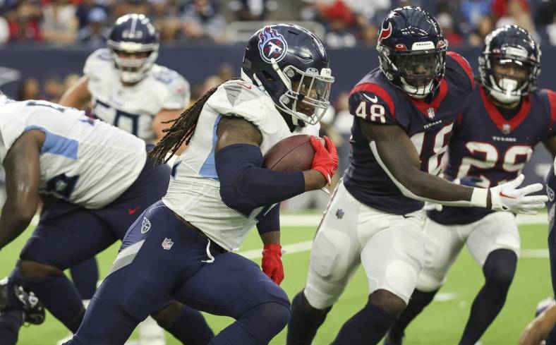 Oct 30, 2022; Houston, Texas, USA; Tennessee Titans running back Derrick Henry (22) runs with the ball during the third quarter against the Houston Texans at NRG Stadium. Mandatory Credit: Troy Taormina-USA TODAY Sports