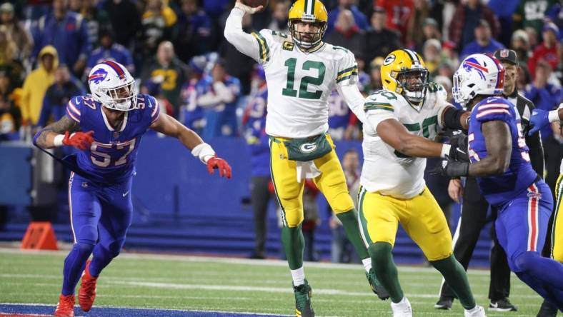 The Packers' Aaron Rodgers  makes a jump pass against the Bills.