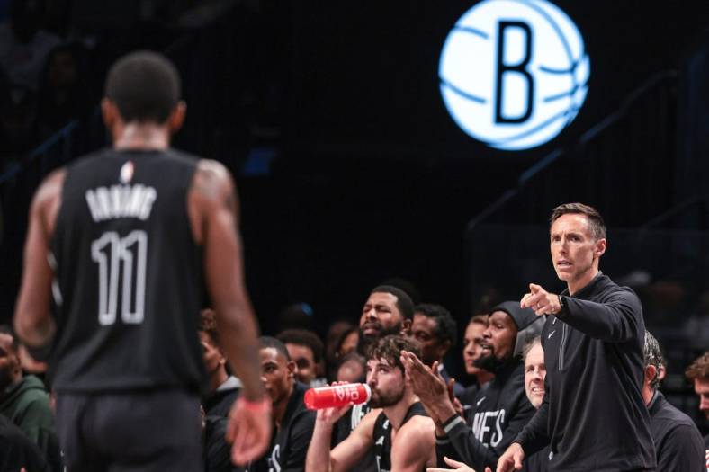 Oct 31, 2022; Brooklyn, New York, USA; Brooklyn Nets head coach Steve Nash (right) points towards guard Kyrie Irving (11) during the first half against the Indiana Pacers at Barclays Center. Mandatory Credit: Vincent Carchietta-USA TODAY Sports