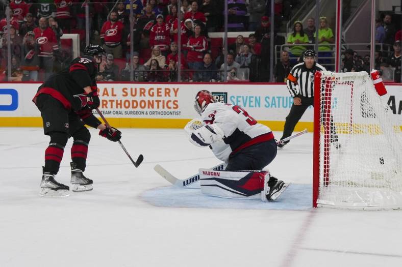 Oct 31, 2022; Raleigh, North Carolina, USA; Carolina Hurricanes right wing Andrei Svechnikov (37) scores a goal during a shootout past Washington Capitals goaltender Darcy Kuemper (35) at PNC Arena. Mandatory Credit: James Guillory-USA TODAY Sports