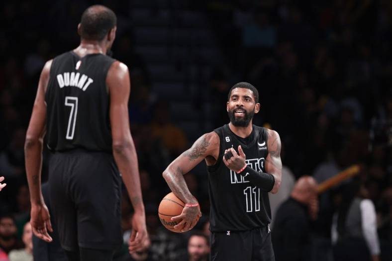Oct 31, 2022; Brooklyn, New York, USA; Brooklyn Nets guard Kyrie Irving (11) talks with forward Kevin Durant (7) during the second half against the Indiana Pacers at Barclays Center. Mandatory Credit: Vincent Carchietta-USA TODAY Sports