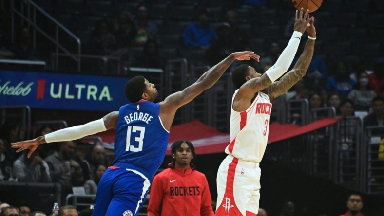 Oct 31, 2022; Los Angeles, California, USA; Houston Rockets guard Kevin Porter Jr. (3) shoots the ball defended by LA Clippers guard Paul George (13) in the first half  at Crypto.com Arena. Mandatory Credit: Richard Mackson-USA TODAY Sports
