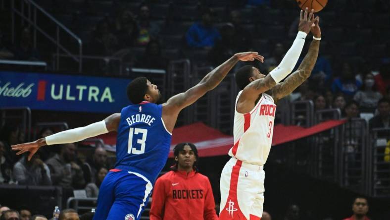 Oct 31, 2022; Los Angeles, California, USA; Houston Rockets guard Kevin Porter Jr. (3) shoots the ball defended by LA Clippers guard Paul George (13) in the first half  at Crypto.com Arena. Mandatory Credit: Richard Mackson-USA TODAY Sports