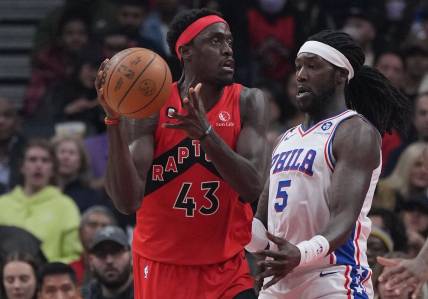 Oct 28, 2022; Toronto, Ontario, CAN; Toronto Raptors forward Pascal Siakam (43) controls the ball as Philadelphia 76ers center Montrezl Harrell (5) tries to defend during the first quarter at Scotiabank Arena. Mandatory Credit: Nick Turchiaro-USA TODAY Sports