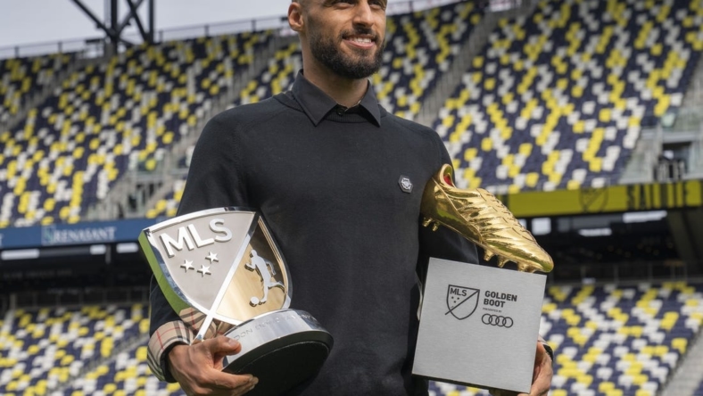 Nov 1, 2022; Nashville, Tennessee, USA;Nashville SC's Hany Mukhtar holds his Landon Donovan MLS MVP and his MLS Golden Boot awards as he poses for a portrait at Geodis Park.  Mandatory Credit: George Walker IV - USA TODAY Sports