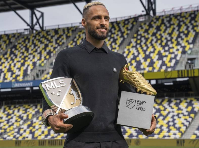 Nov 1, 2022; Nashville, Tennessee, USA;
Nashville SC's Hany Mukhtar holds his Landon Donovan MLS MVP and his MLS Golden Boot awards as he poses for a portrait at Geodis Park.  Mandatory Credit: George Walker IV - USA TODAY Sports