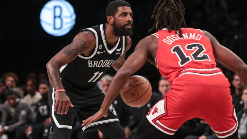 Nov 1, 2022; Brooklyn, New York, USA; Brooklyn Nets guard Kyrie Irving (11) dribbles as Chicago Bulls guard Ayo Dosunmu (12) defends during the first quarter at Barclays Center. Mandatory Credit: Vincent Carchietta-USA TODAY Sports