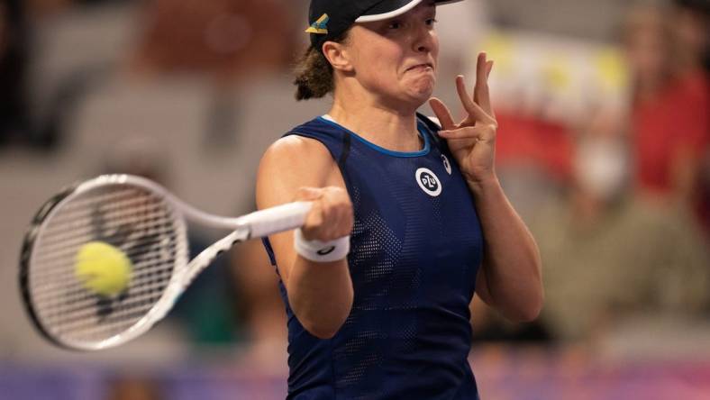 Nov 1, 2022; Forth Worth, TX, USA; Iga Swiatek (POL) returns a shot during her match against Daria Kasatkina on day two of the WTA Finals at Dickies Arena. Mandatory Credit: Susan Mullane-USA TODAY Sports